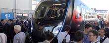 (FILES) In this file photo taken on September 18, 2018 visitors crowd around a subway train in lightweight construction by Chinese company China Railroad Rolling Stock Corporation (CRRC) at the InnoTrans International Trade Fair for Transport Technology in Berlin. - The Chinese giant CRRC owns 46 subsidiaries and employs 180.000 employees according to its website. (Photo by Wolfgang Kumm / dpa / AFP) / Germany OUT