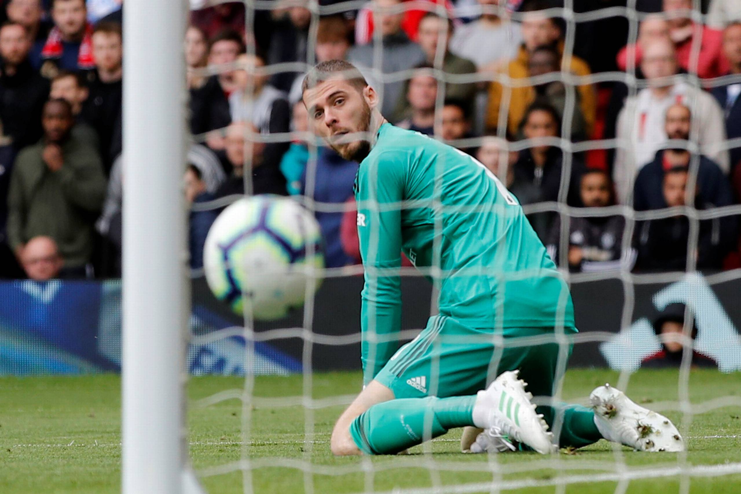 Soccer Football - Premier League - Manchester United v Chelsea - Old Trafford, Manchester, Britain - April 28, 2019 Chelsea's Marcos Alonso scores their first goal as Manchester United's David de Gea looks on REUTERS/Phil Noble EDITORIAL USE ONLY.No use with unauthorized audio, video, data, fixture lists, club/league logos or "live" services. Online in-match use limited to 75 images, no video emulation.No use in betting, games or single club/league/player publications. Please contact your account representative for further details. TPX IMAGES OF THE DAY  
