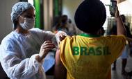 FILE PHOTO: A health worker administers a dose of Johnson & Johnson vaccine against the coronavirus disease (COVID-19) to a resident as he takes a selfie, during mass vaccination at the Ilha Grande island, one of the most famous tourist spots in Rio de Janeiro state, Brazil, July 10, 2021. REUTERS/Lucas Landau/File Photo