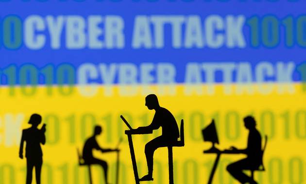 Figurines with computers and smartphones are seen in front of the words "Cyber Attack", binary codes and the Ukrainian flag, in this illustration taken February 15, 2022. REUTERS/Dado Ruvic/Illustration