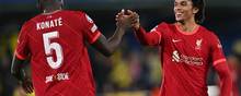 Liverpool's English defender Trent Alexander-Arnold (R) and Liverpool's French defender Ibrahima Konate shake hands as they celebrate at the end of the UEFA Champions League semi final second leg football match between Liverpool and Villarreal CF at La Ceramica stadium in Vila-real on May 3, 2022. (Photo by Paul ELLIS / AFP)