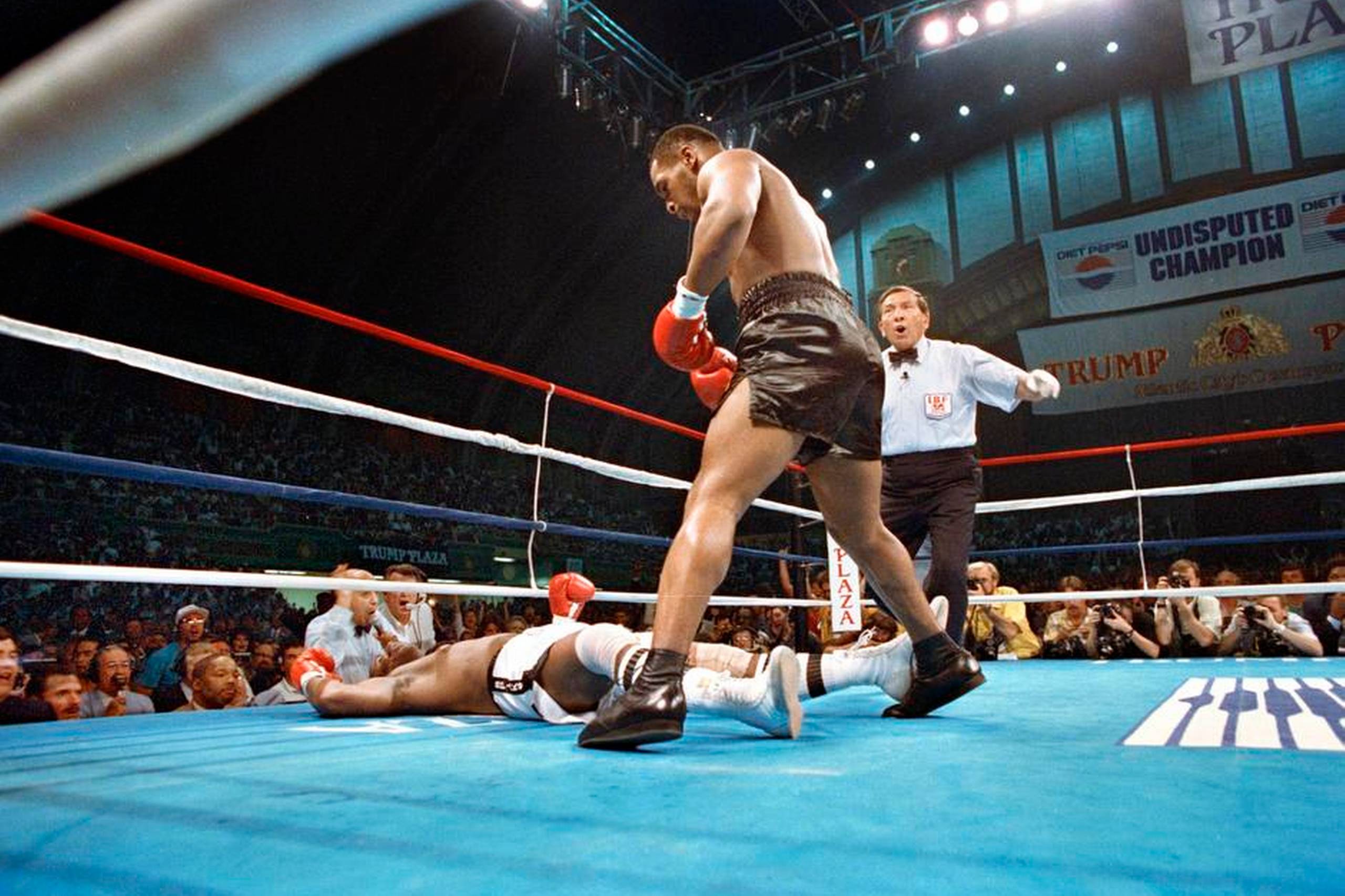 Både Michael Spinks og Mike Tyson var ubesejrede, da de i 1988 i Atlantic City kæmpede om tre VM- bælter. Allerede efter et minut kom Spinks i store vanskeligheder, og efter blot 91 sekunders boksning var kampen slut med Spinks liggende på gulvet. Foto: Richard Drew/AP