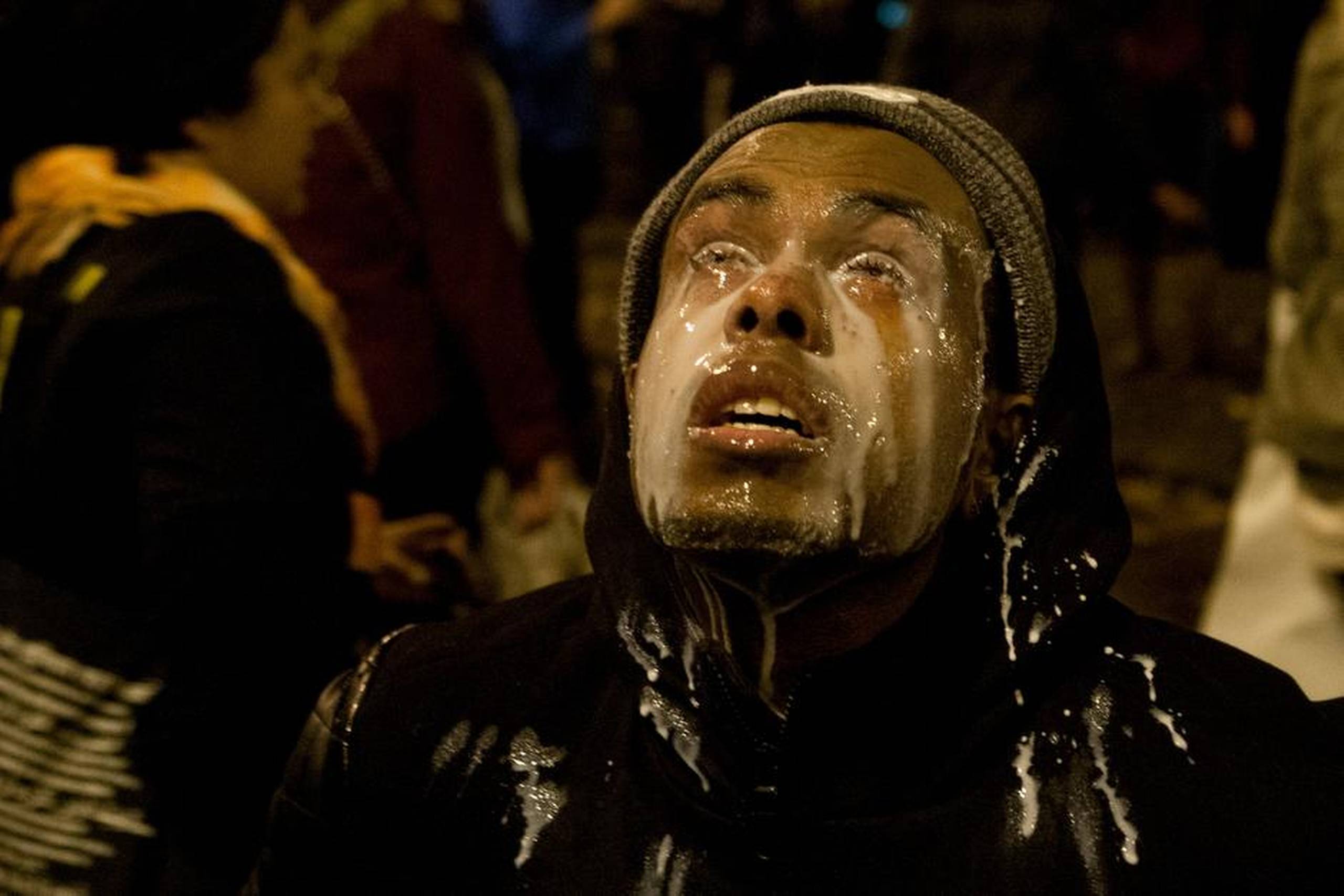 En demonstrant hælder mælk i øjnene mod tåregas, som blev brugt af politiet i Seattle, efter at protesterne også nåede til staten Washington. Foto: Anna Erickson/AP