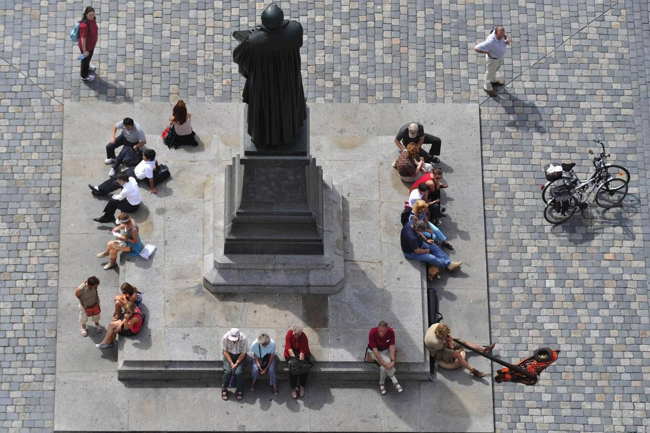 Tourists sit around the Martin-Luther-Memorial statue at the square Neumarkt in Dresden, Germany, Thursday, Aug. 14, 2008. (AP Photo/Matthias Rietschel)
